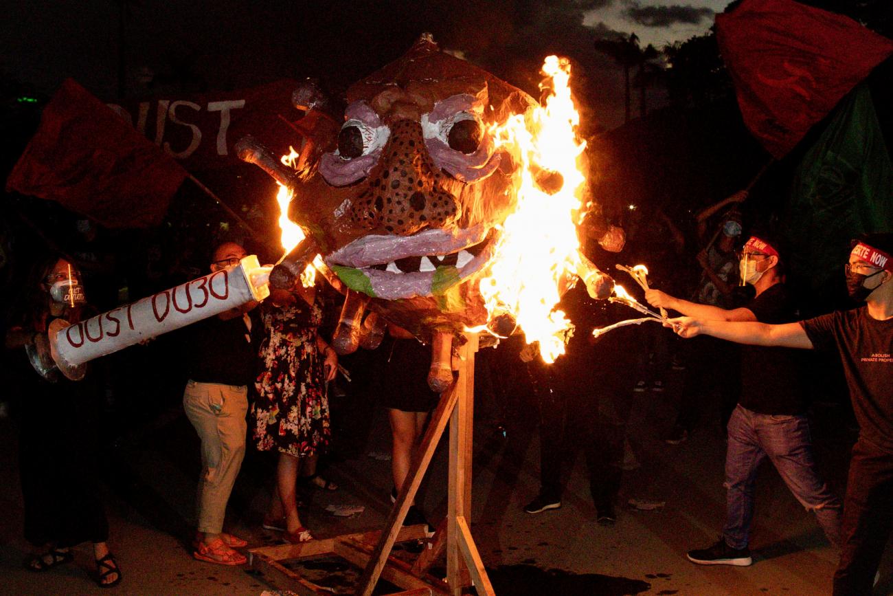 Activists burn an effigy dubbed "Duterte Virus" during a protest in Quezon City, Metro Manila, Philippines on September 21, 2020.