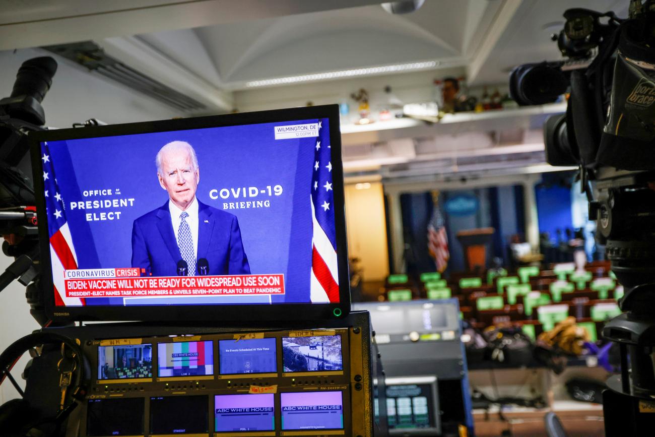 President Joe Biden is seen making remarks on his plan to fight COVID-19 on a television monitor from the White House Briefing Room in Washington, DC on November 9, 2020.