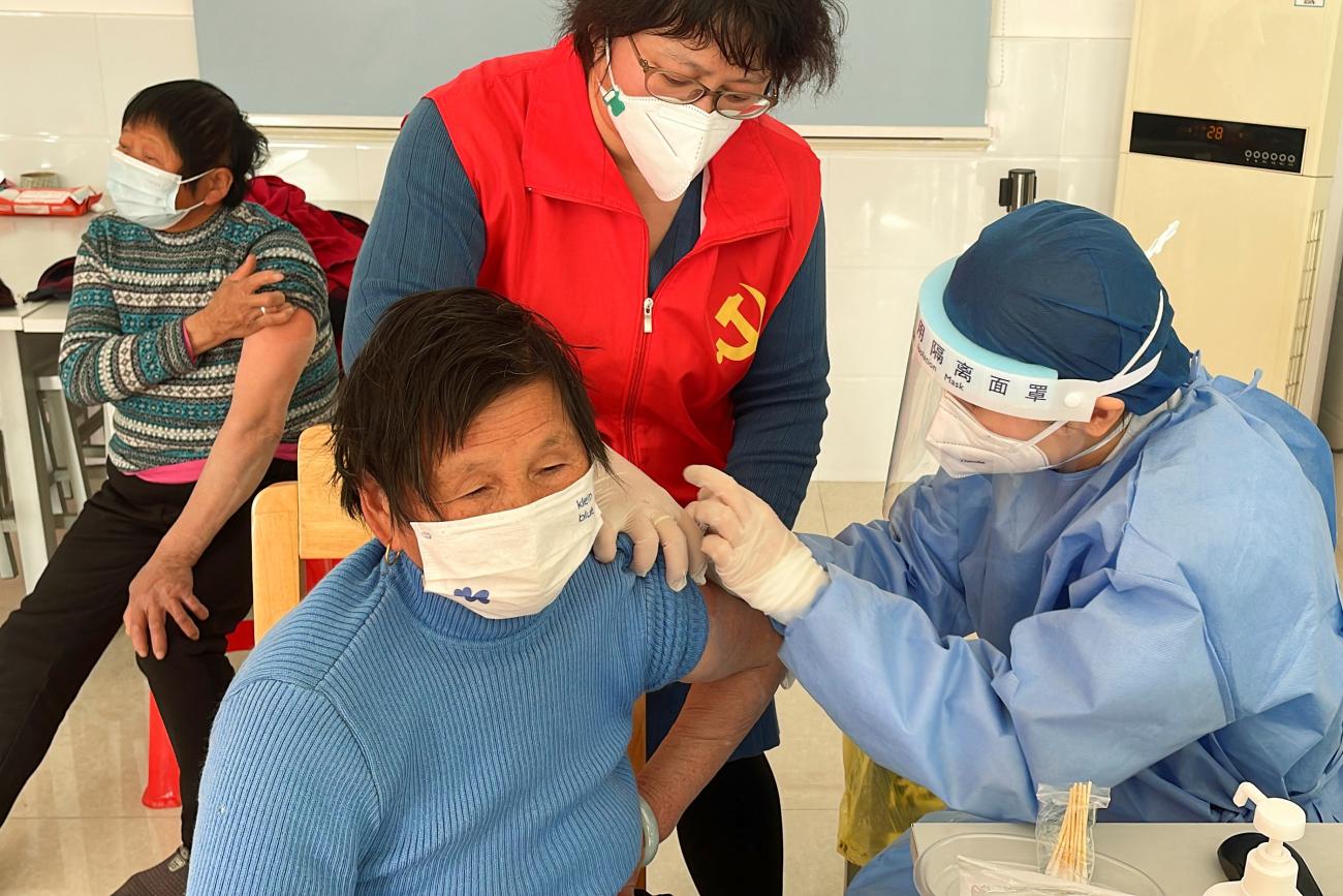 A medical worker administers a dose of a vaccine against COVID-19, during a government-organized visit to a vaccination center in the outskirts of Shanghai, China, December 21, 2022.