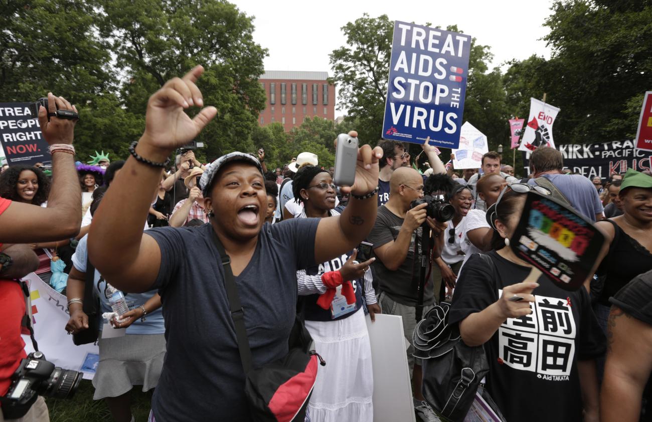 AIDS activists sing and chant during a rally across from the White House in Washington on July 24, 2012. 