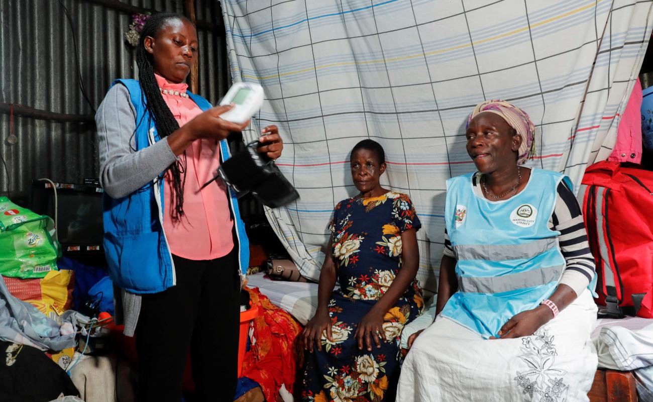 Kenyan Community health workers (CHWs) attend to Emily Auma Odongo, 56, a patient inside her shelter after a failed medical appointment at the Kenyatta National Hospital as public hospital doctors continue their strike to demand payment of their salary arrears and the immediate hiring of trainee doctors, in the Mathare settlement of Nairobi, Kenya April 2, 2024.