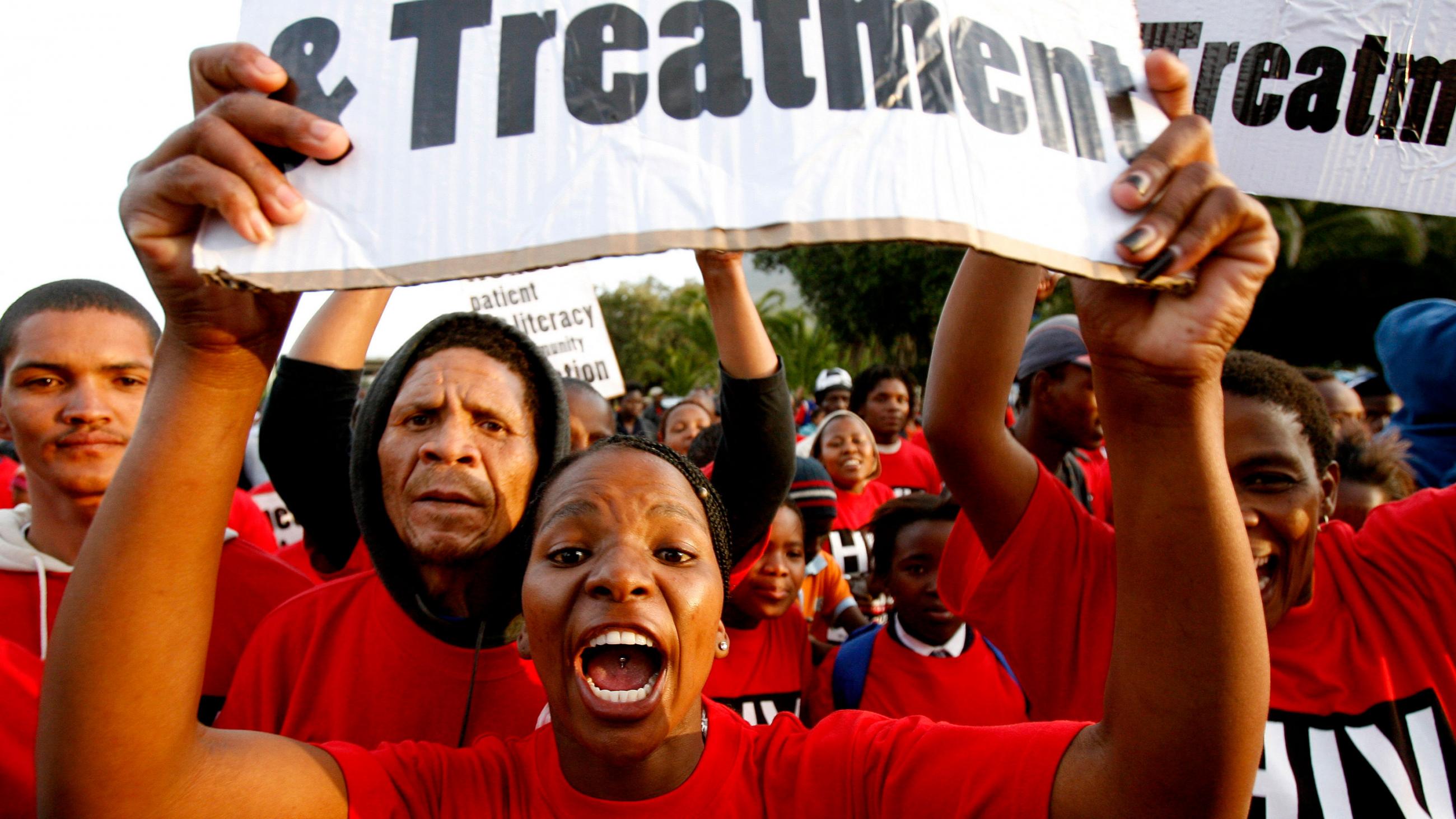Demonstrators march through the streets of Cape Town to highlight the need for new strategies and medicines to curb the spread of tuberculosis on November 8, 2007. Picture shows a crowd of people wearing red shirts with a woman at center shouting into the camera