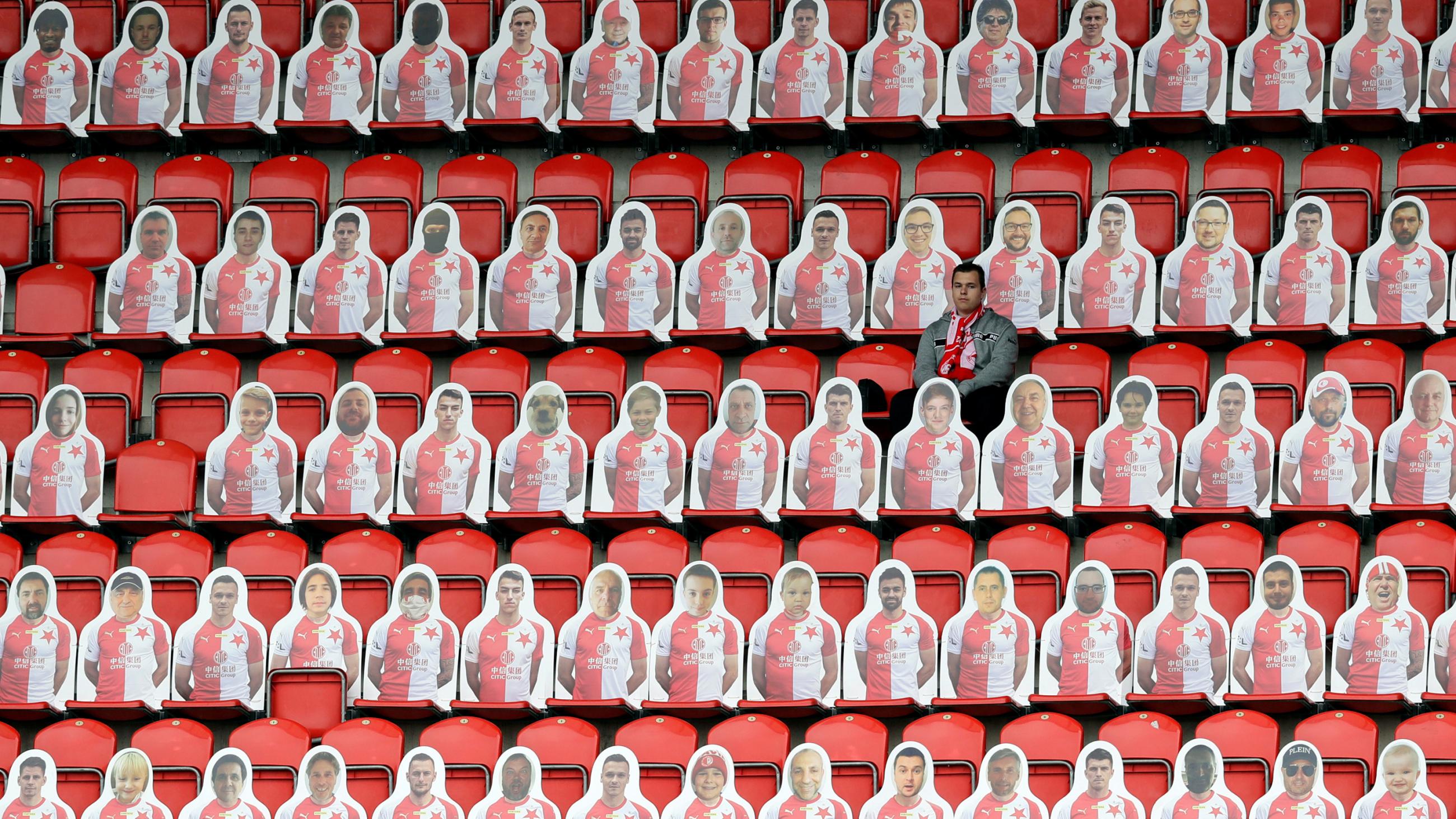 The photo shows the bleacher seats of a stadium filled with cardboard cutouts. 
