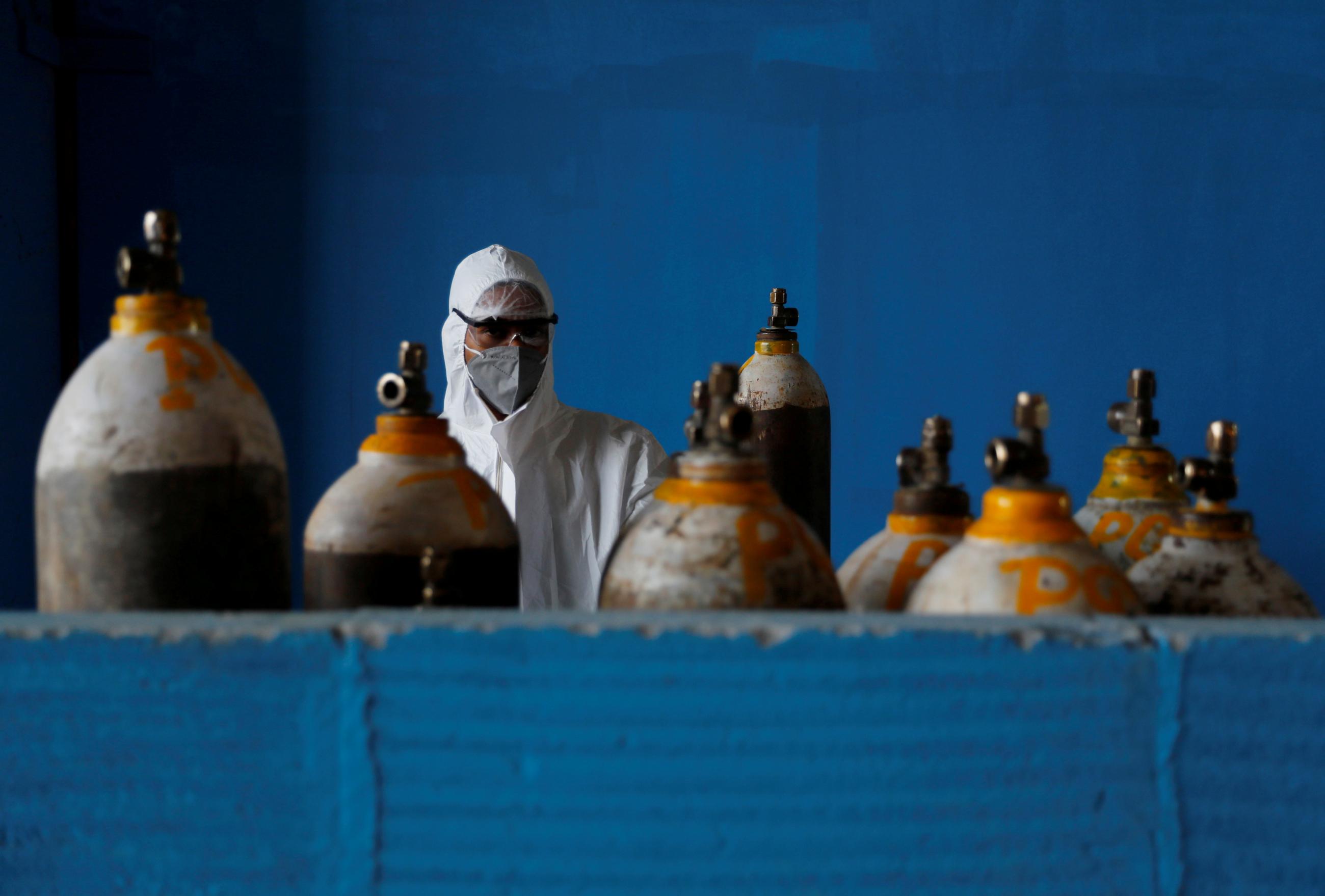A medical worker stands in a blue room filled with oxygen cylinders at the Yatharth Hospital in Noida, on the outskirts of New Delhi, India, on September 15, 2020. Photo by REUTERS/Adnan Abidi 