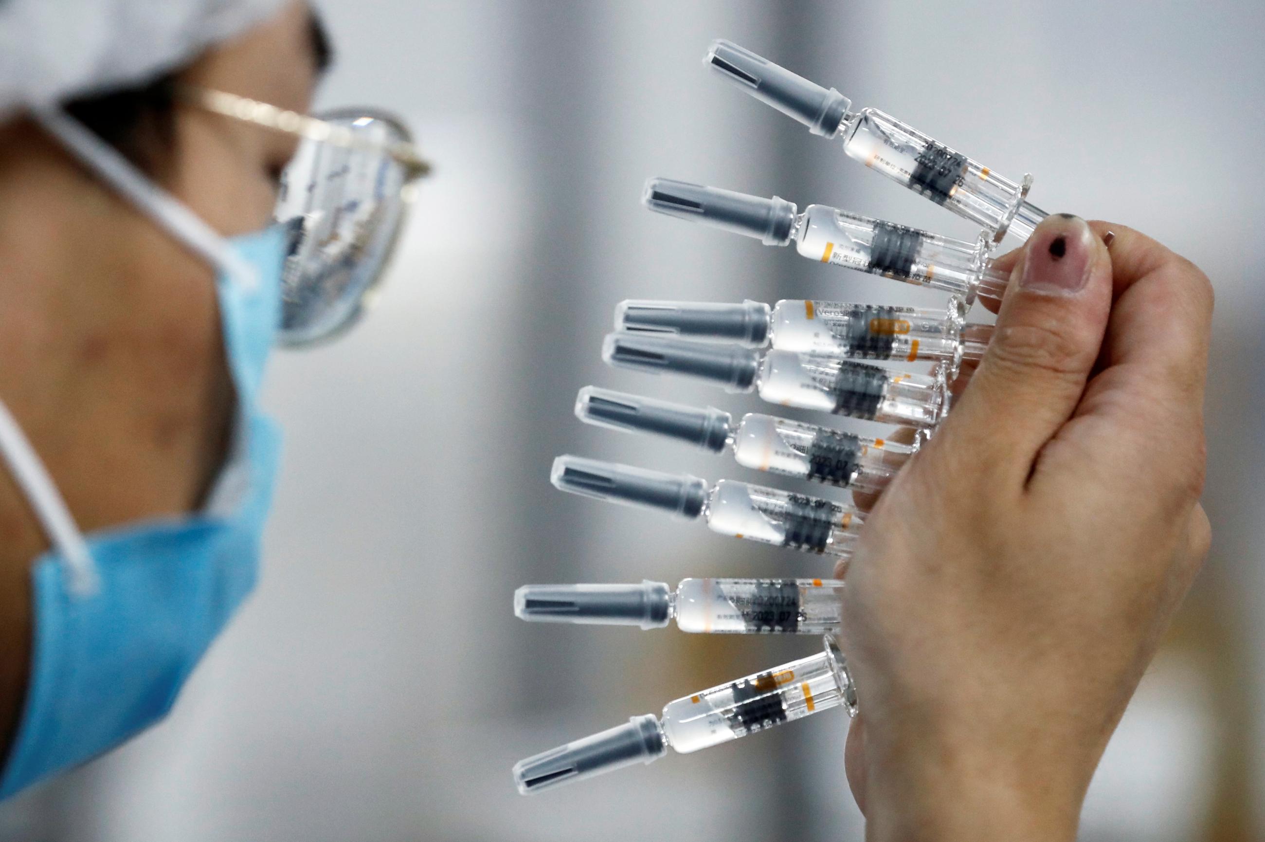 A worker performs a quality check in the packaging facility of Chinese vaccine maker Sinovac Biotech, developing an experimental coronavirus disease (COVID-19) vaccine, during a government-organized media tour in Beijing on September 24, 2020.