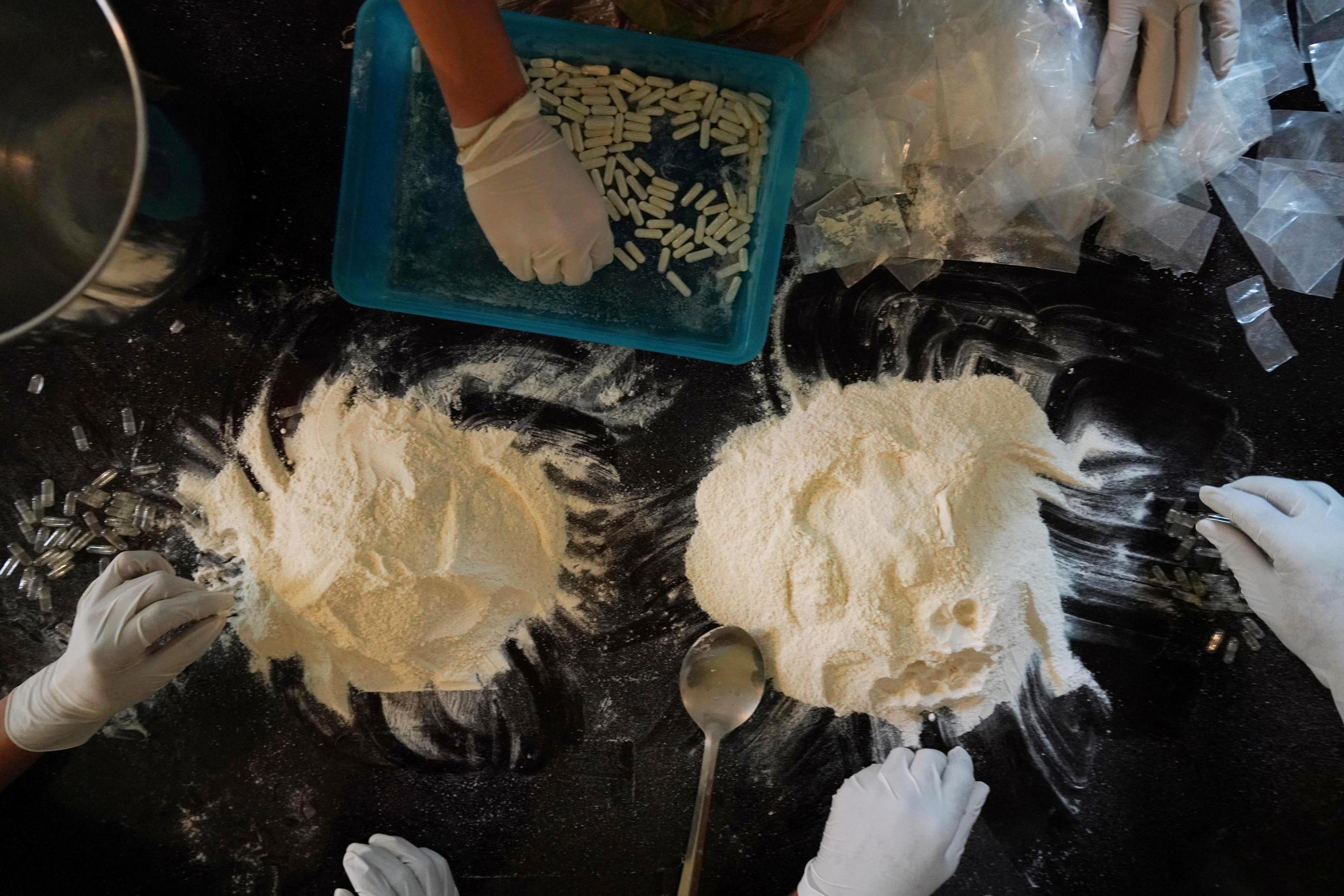 Members of the Sinaloa Cartel prepare capsules with methamphetamine in a safe house in Culiacan, Mexico, April 4, 2022.