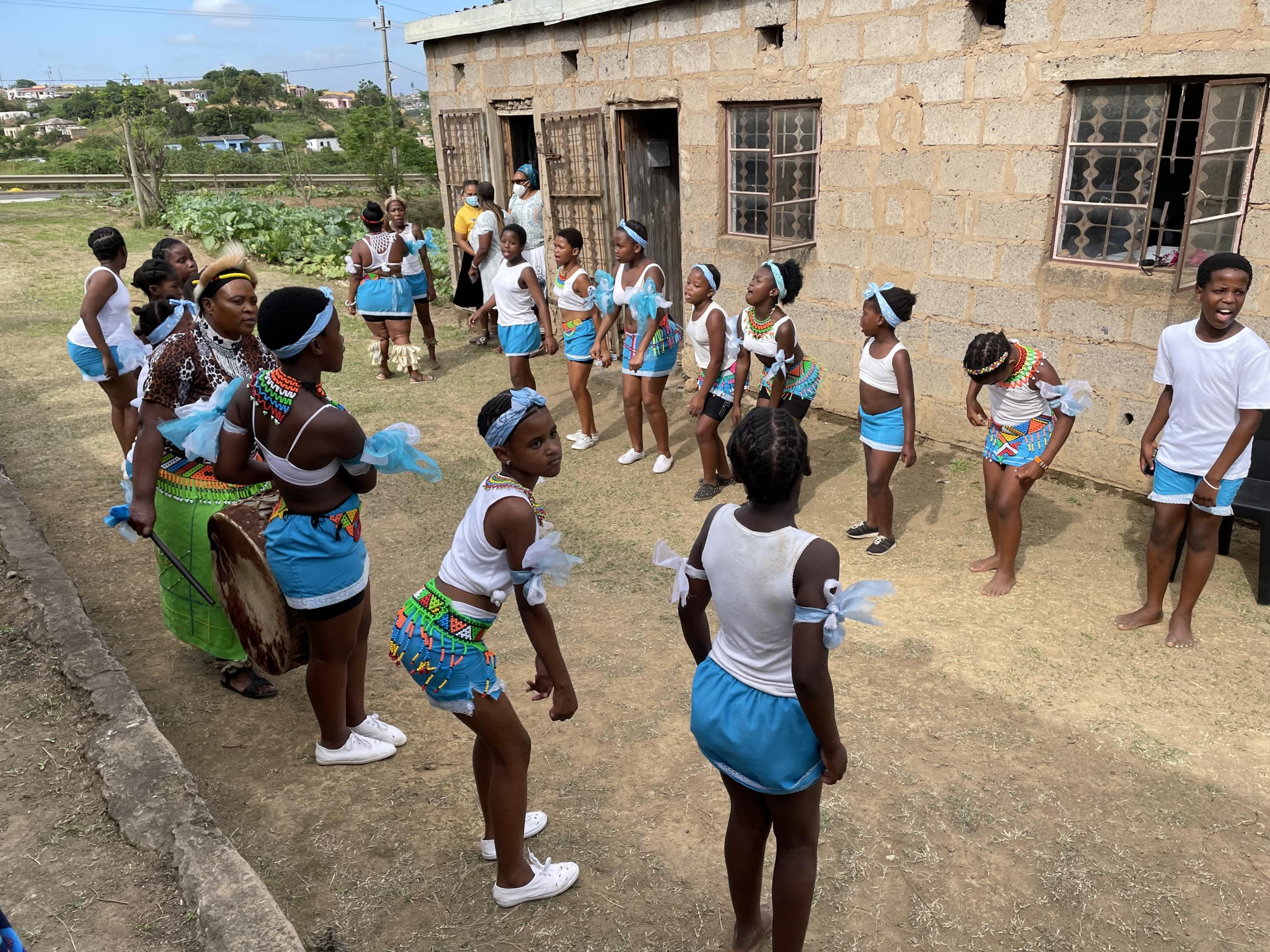 Children stand in a line during a PEPFAR site visit. 