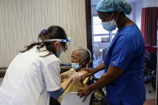 A nursing home resident receives a shot of the coronavirus disease (COVID-19) vaccine at King David Center for Nursing and Rehabilitation, a nursing home facility, in Brooklyn's Bath Beach neighborhood in New York City, U.S., January 6, 2021. 