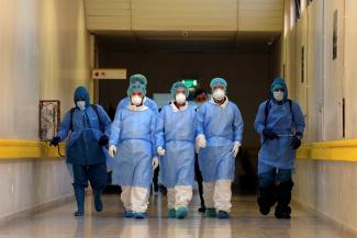 Employees from a disinfection service company wearing protective face masks and gloves.