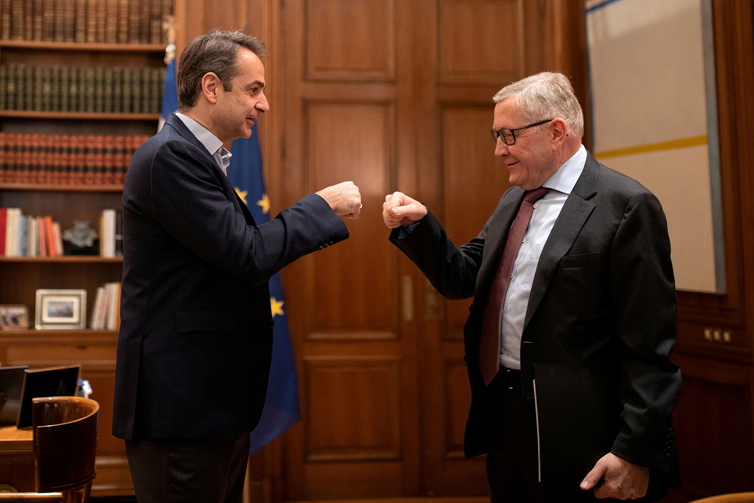 The image shows the two leaders bumping fists and smiling. 