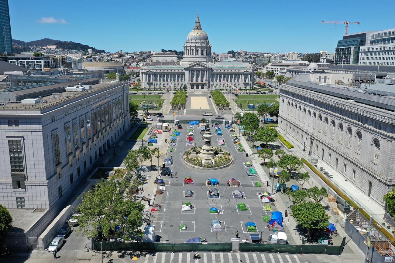 The photo shows a square outlined with grid lines and almost all the defined squares filled with tents.