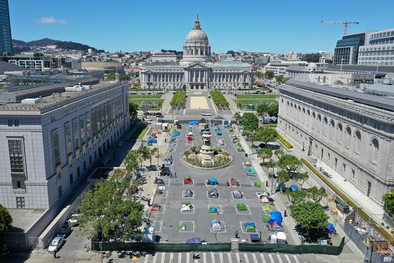 The photo shows a square outlined with grid lines and almost all the defined squares filled with tents. 