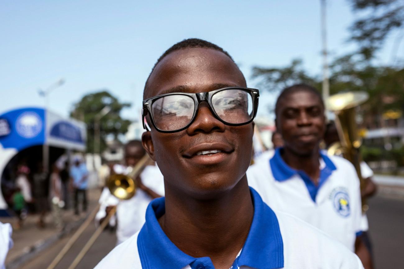 Picture shows Musa smiling at the camera as he walks in the parade. 