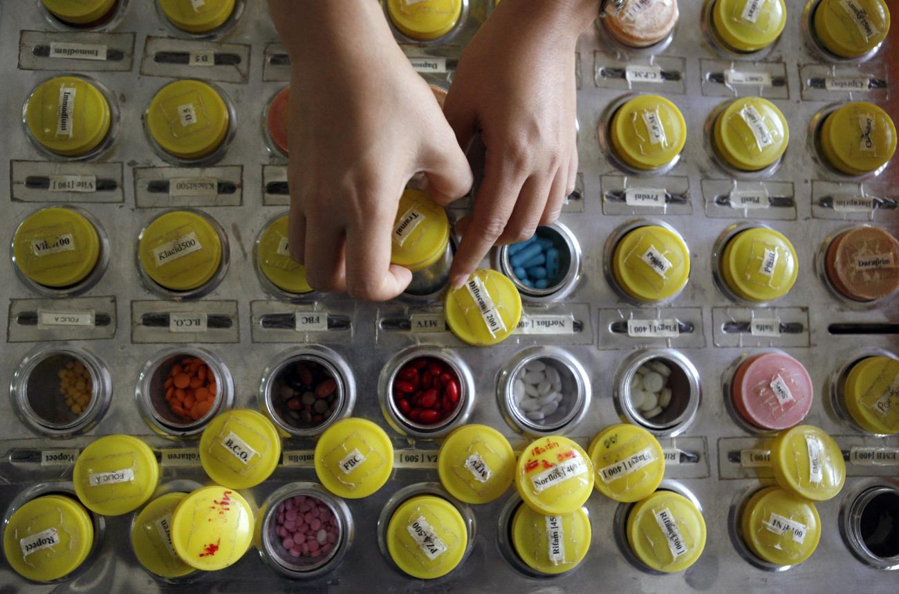 A nurse prepares doses of brand name and generic HIV-AIDS drugs for patients at the Phrabat Nampu Temple in Thailand's Lopburi Province February 17, 2007.