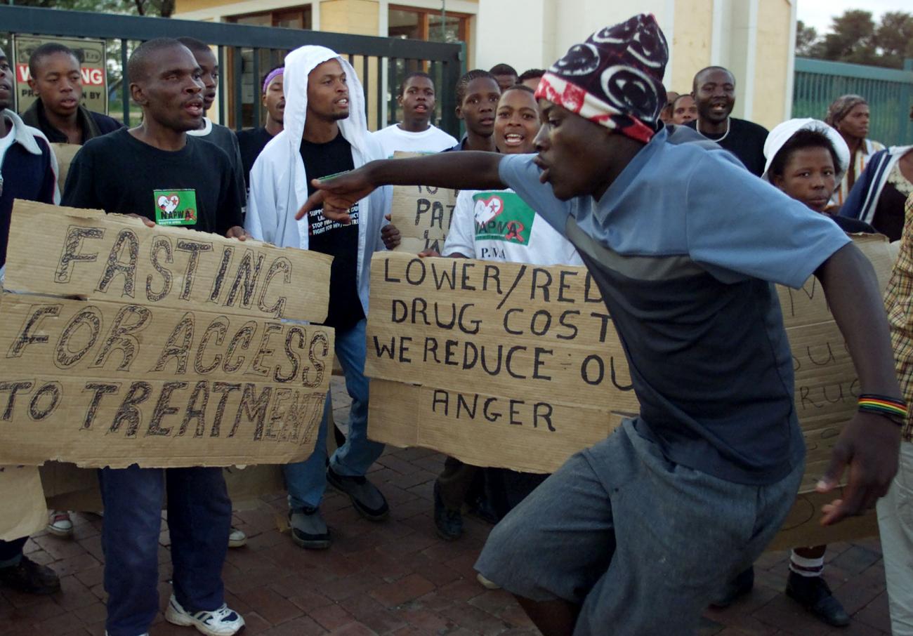 Members of the South African National Association of People Living With HIV/AIDS protest outside the premises of a pharmaceutical company in Johannesburg, South Africa on April 16, 2001.