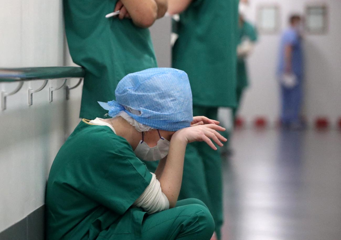 Doctor Ruxandra Divan, rests in the Intensive Care Unit for COVID-19 patients at Hopitaux Civils de Colmar in Colmar, France, on December 15, 2021.  REUTERS/Yves Herman