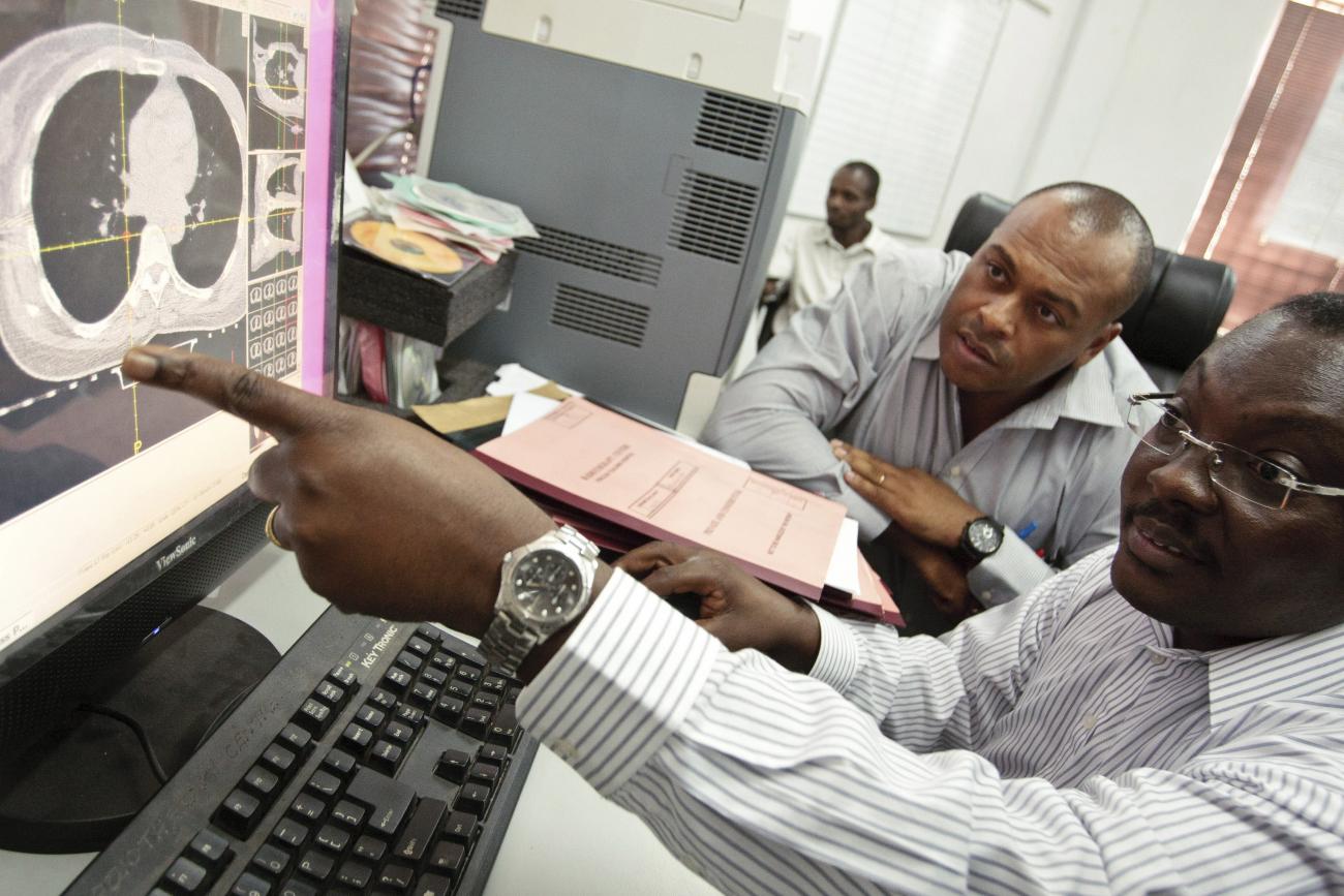 Clinical oncologists look at a scan of a cancer patient on a computer screen at the Korle Bu Teaching Hospital in Accra, Ghana, on April 24, 2012. 