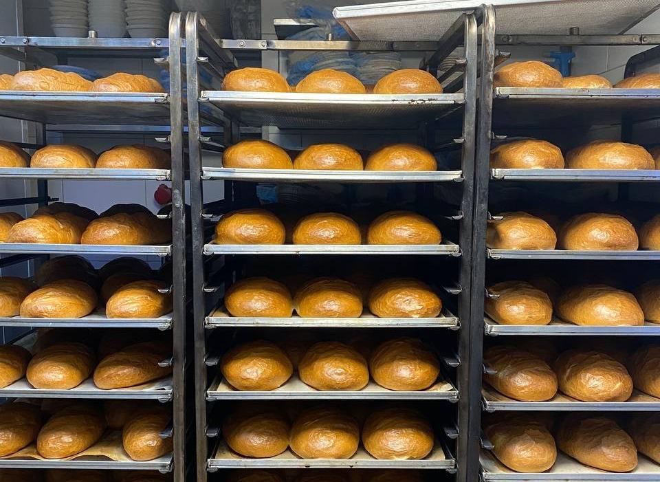 Rows of freshly baked loaves of bread cool on racks at Bakehouse in Kyiv, Ukraine