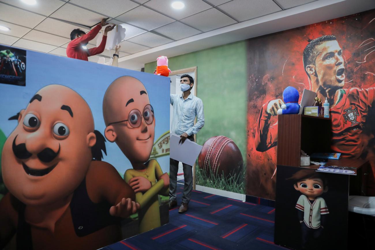 A staff member arranges a soft toy inside the Star Imaging and Path Lab, a pathology lab which has the city's first child-friendly vaccination center in New Delhi, India, on October 22, 2021. 