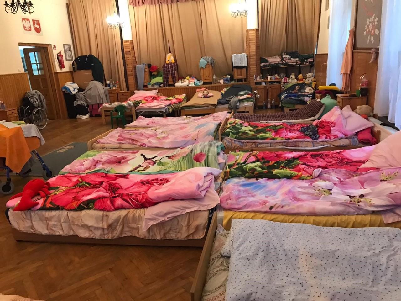 Beds, covered in warm blankets are crowded together in the sleeping quarters at the Sanatorium, in Krasnobród, Poland. 