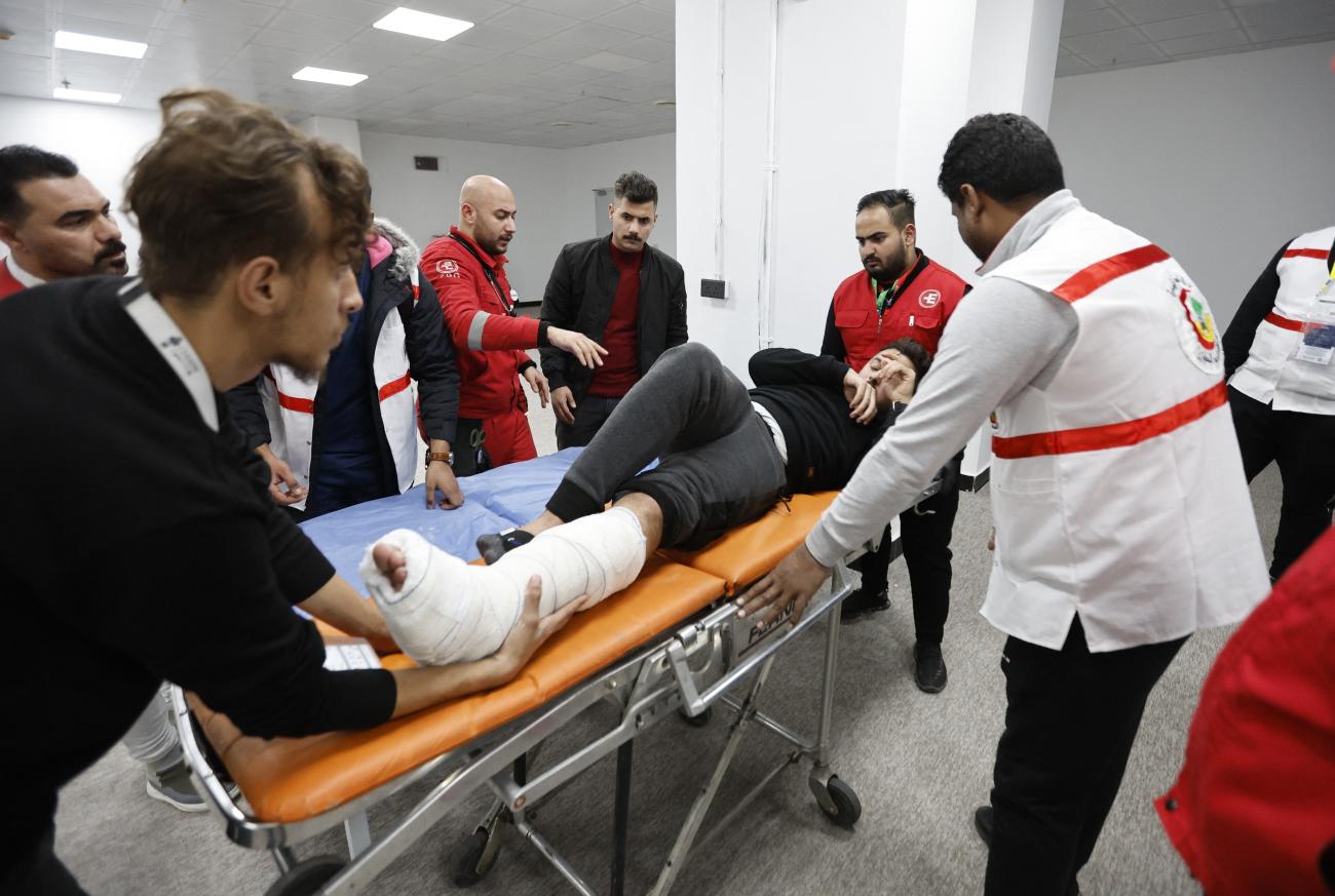 A fan lies on a gurney and receives medical attention after sustaining an injury before the final match (Iraq vs. Oman), of the 25th Arabian Gulf Cup, in Basra International Stadium, Basra, Iraq, on January 19, 2023.