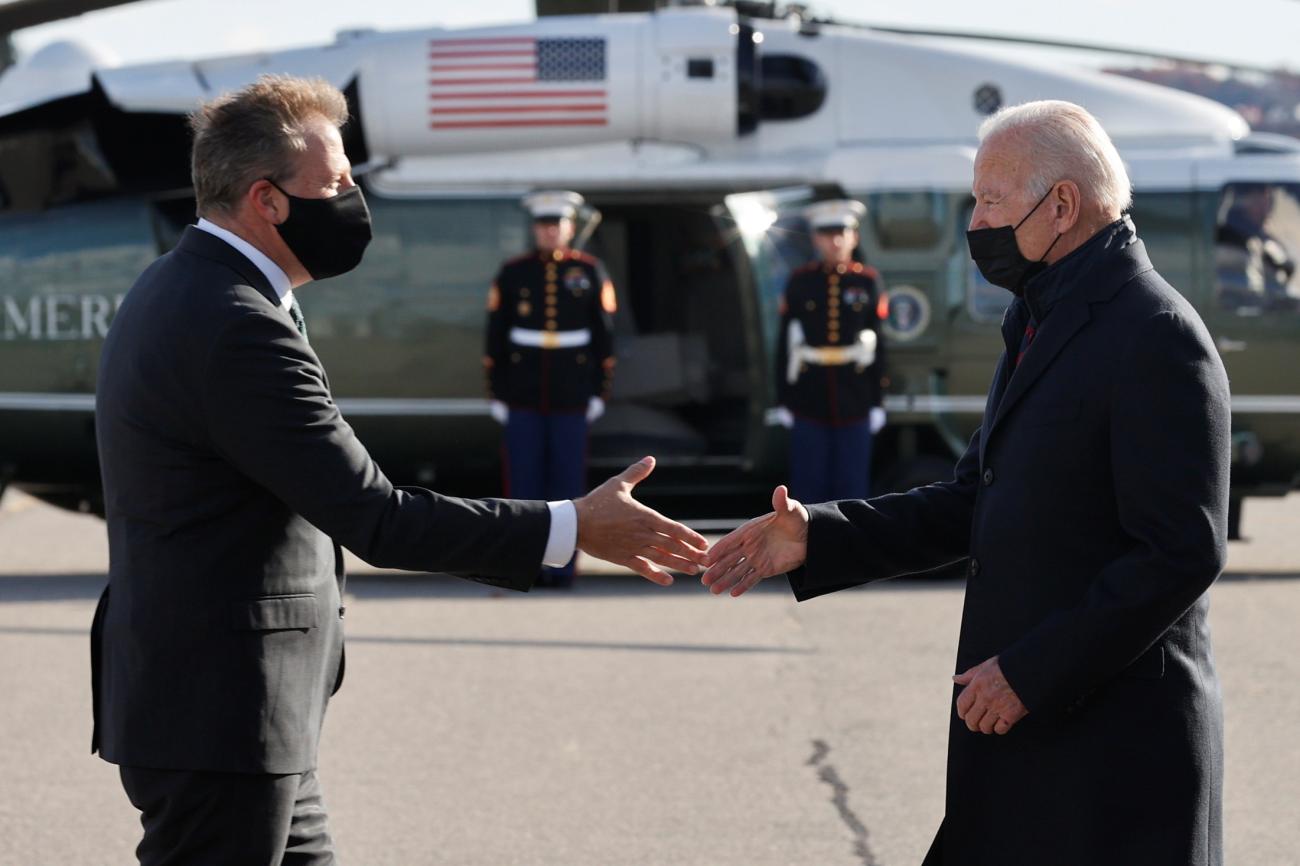 New Hampshire Governor Chris Sununu greets U.S. President Joe Biden as he arrives at Manchester-Boston Regional Airport in Manchester, New Hampshire, U.S., November 16, 2021