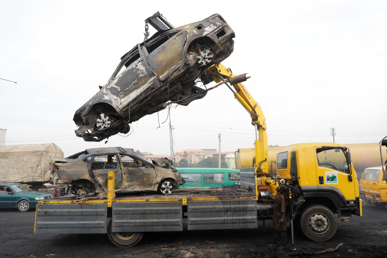 A car is lifted onto a truck after a fire accident involving an oil tanker along the Lagos-Ibadan expressway.