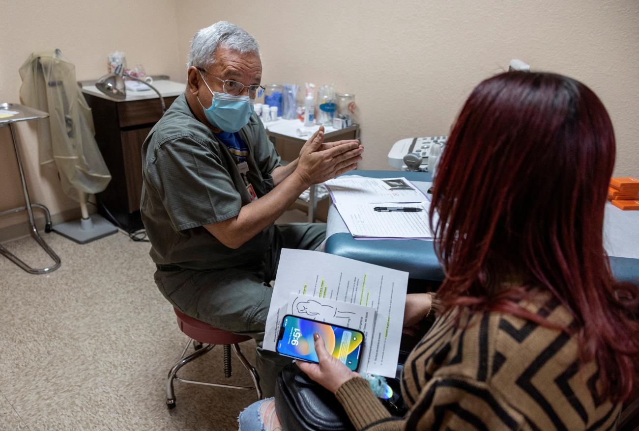 Franz Theard, MD, speaks with a patient at his clinic, the Women's Reproductive Clinic of New Mexico.
