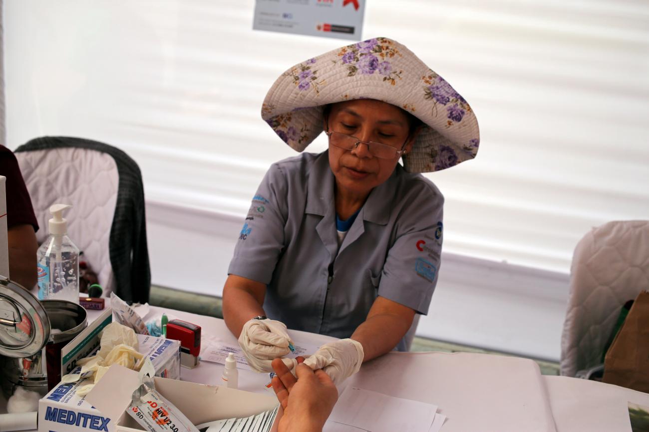 A nurse takes blood for a free HIV test during a HIV prevention campaign marking the World AIDS Day.