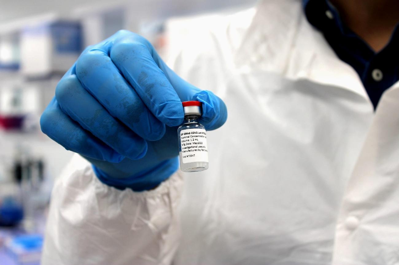 A researcher holds a vial inside a laboratory during the development of the Italian ReiThera COVID-19 vaccine,