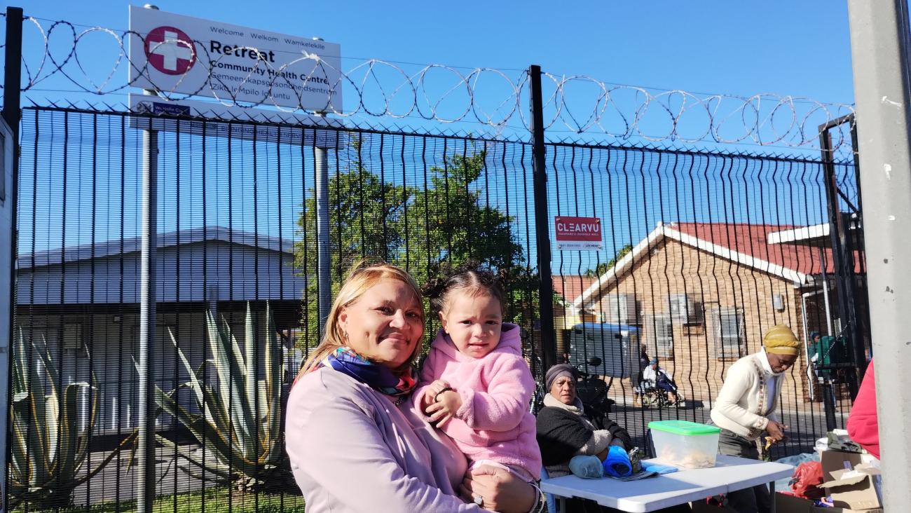 Shameema De La Cruz is frustrated that she must wait the whole day for her 18- month-old daughter to be seen at a public sector health center in Cape Town, South Africa. 