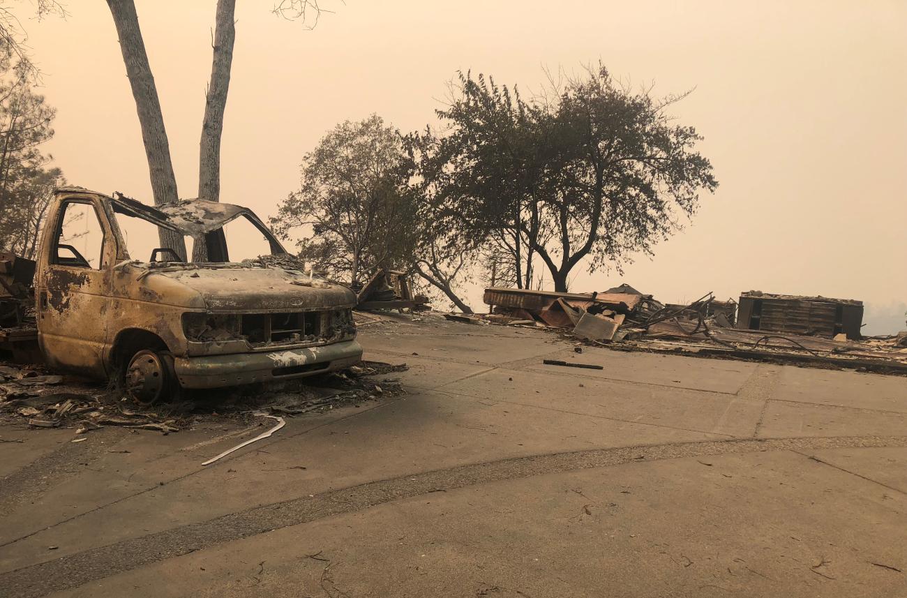 The wreckage of a vehicle is seen along the road in the aftermath of wildfires in Paradise, California, U.S., November 12, 2018. 