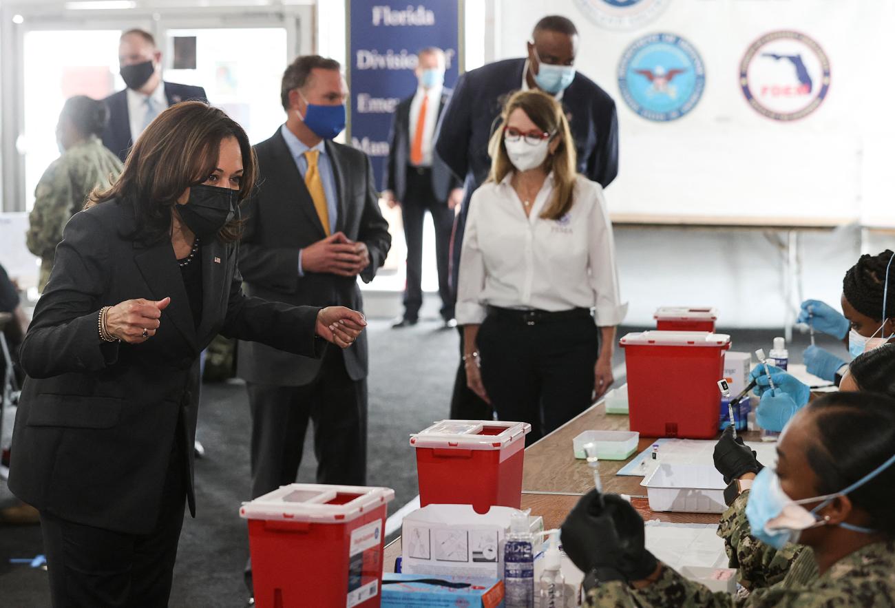 U.S. Vice President Kamala Harris greets U.S. Navy personnel preparing syringes with the Pfizer COVID-19 vaccine during a tour of a FEMA vaccination site in Jacksonville, Florida, on March 22, 2021.