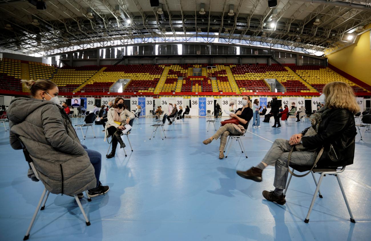 People rest after receiving a dose of Russia's Sputnik V COVID-19 vaccine at a sport center.