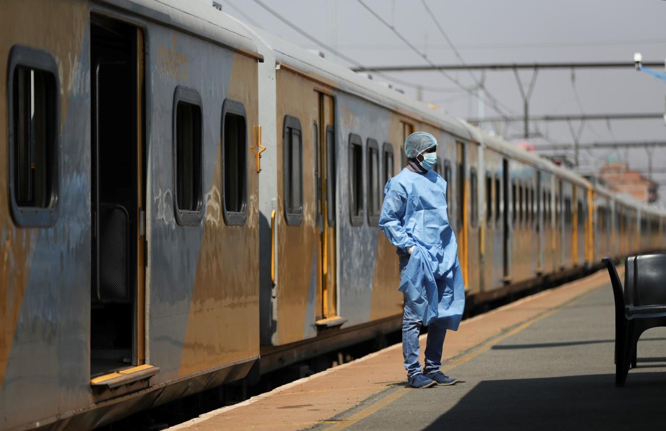 A health worker takes a break at a vaccination center at the Springs train station.