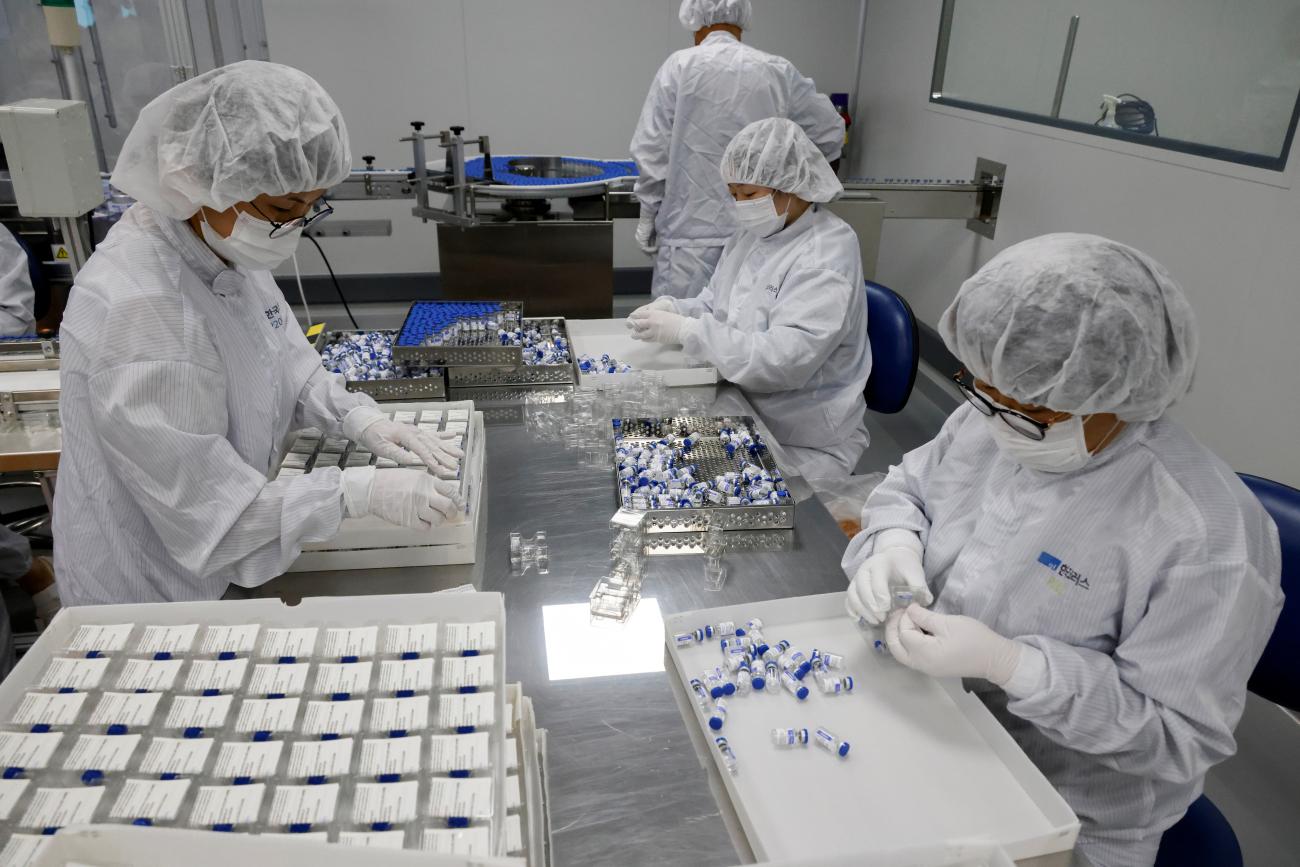 Employees work at a Hankook Korus Pharm production factory for Russia's COVID-19 vaccine, Sputnik.