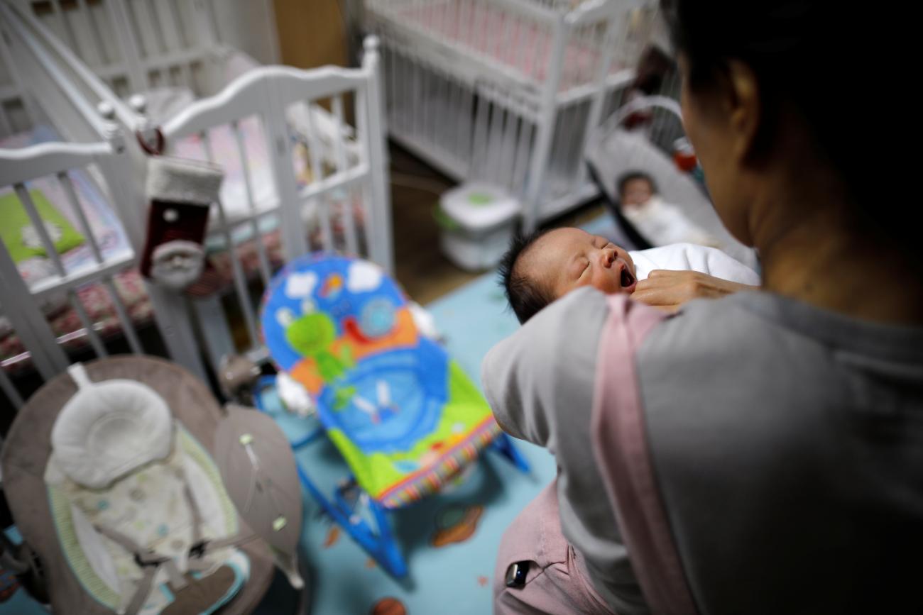 A volunteer takes care of a baby who was left in a baby box at Jusarang Community Church.