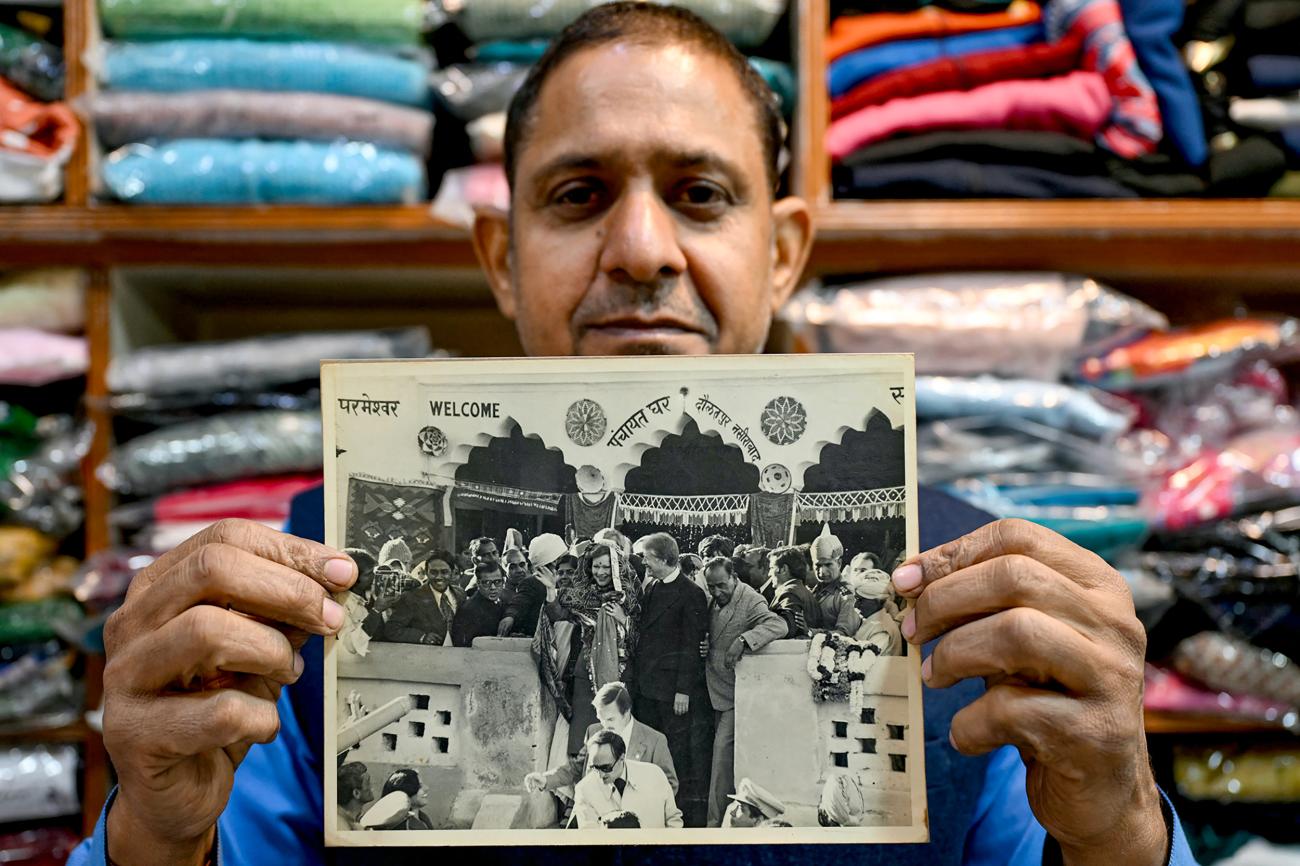 Rajiv Kumar shows a photograph of late former U.S. President Jimmy Carter and his wife Eleanor Rosalynn Carter during their visit to the village in 1978, in Gurgaon, India, on January 7, 2025.