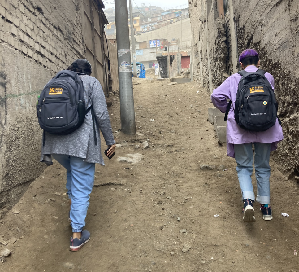 Two CASITA employees walk door-to-door to conduct children’s development evaluations in Carabayllo, Lima, on August 24, 2022