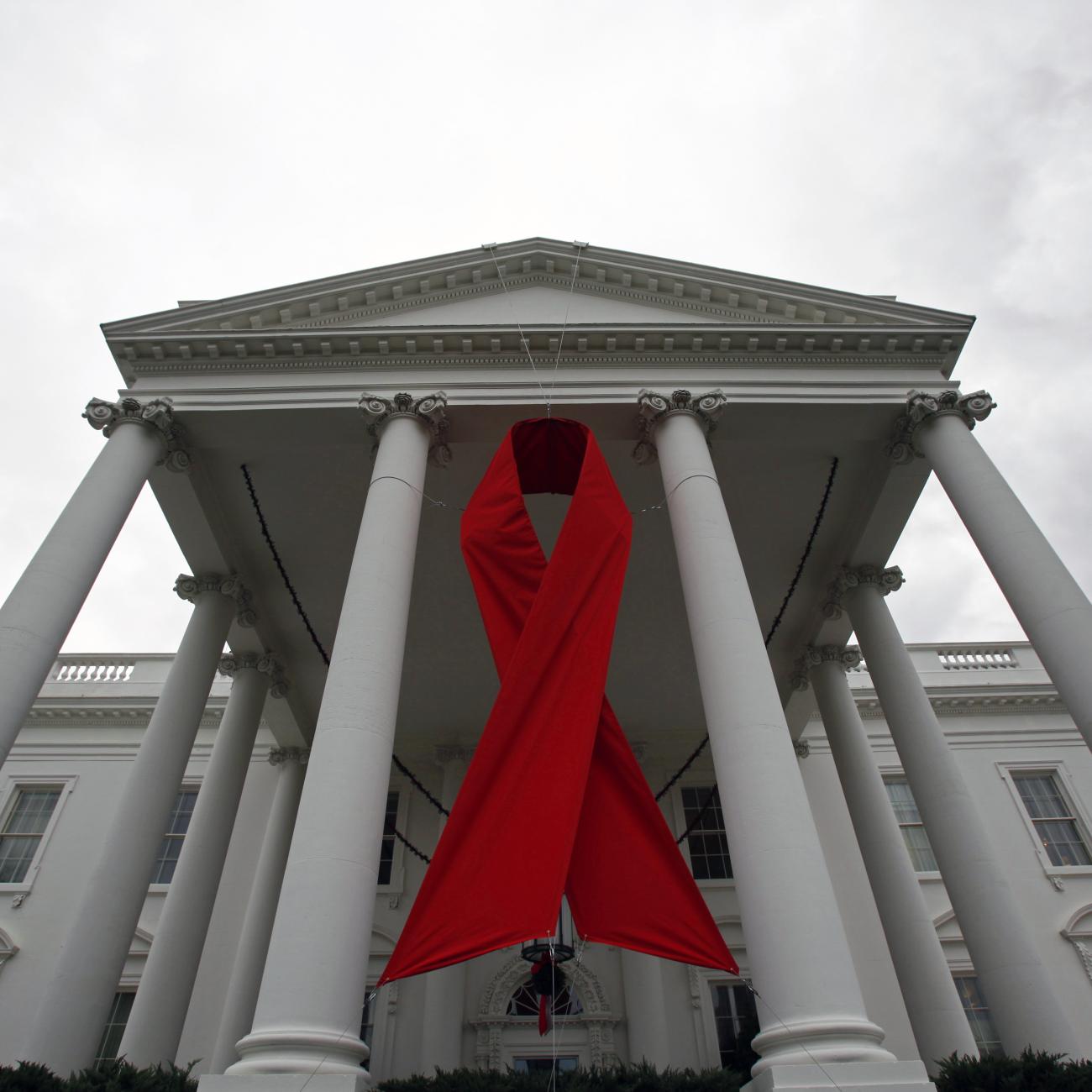 An AIDS ribbon hangs from the North Portico of the White House.