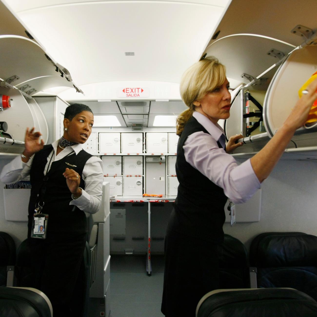 Frontier Airlines flight attendants check safety equipment