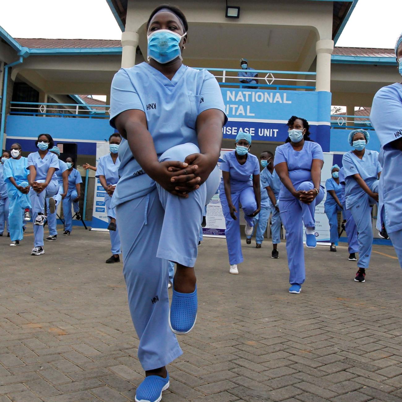 Nurses participate in a fitness program during the COVID-19 outbreak, within the Infectious Disease Unit grounds of the Kenyatta National Hospital.