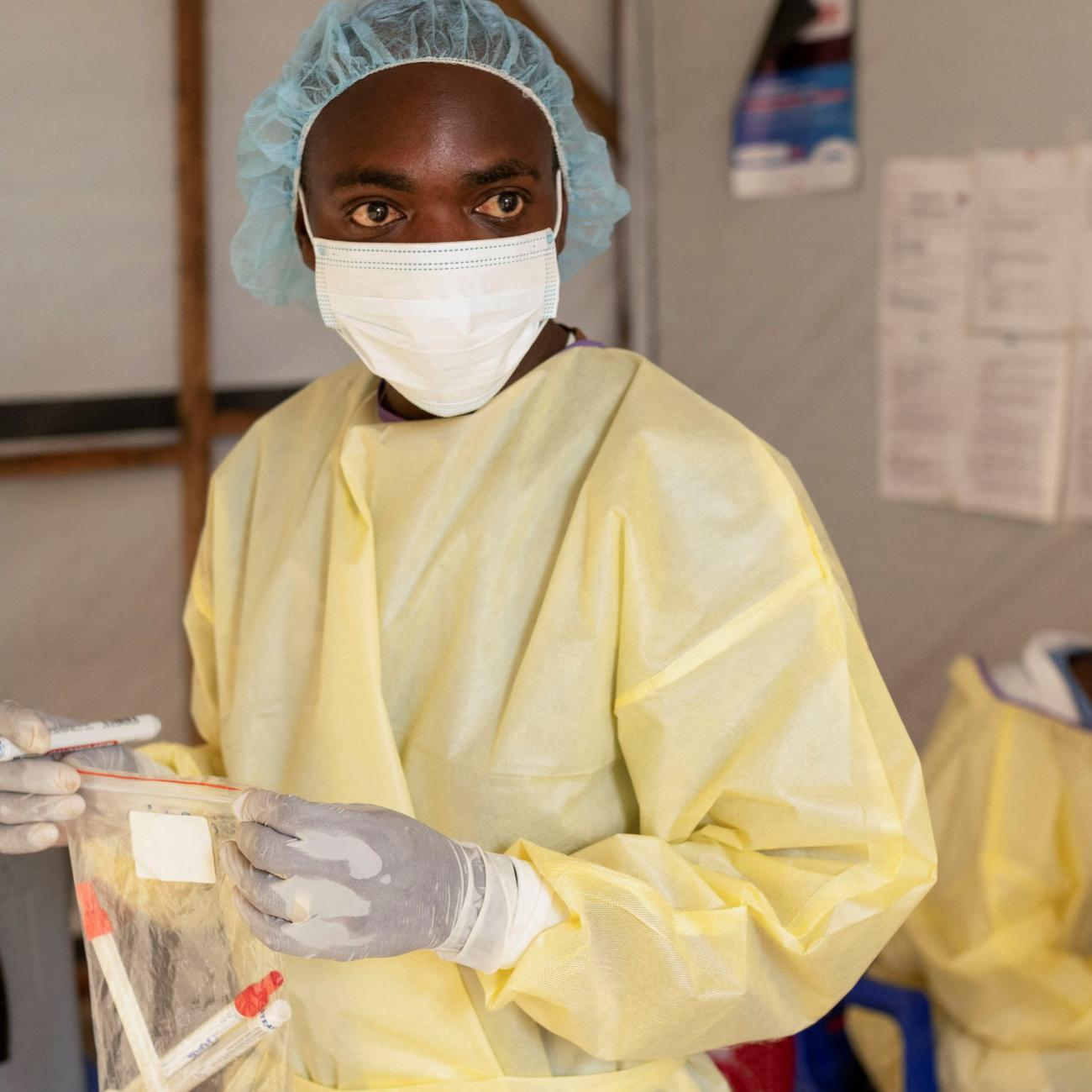 A laboratory nurse carries samples taken from a child with a suspected case of mpox.