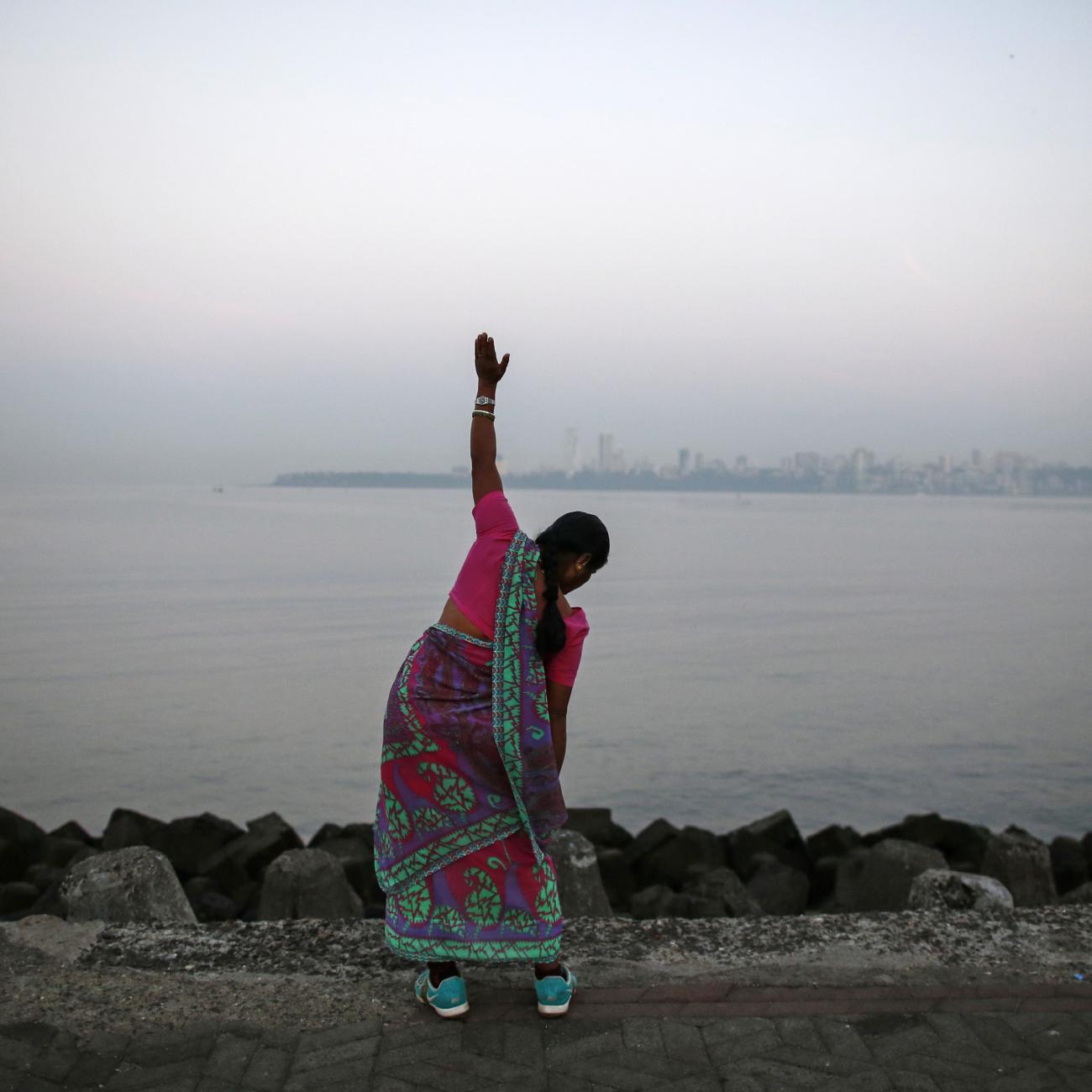 A woman exercises along the Arabian Sea.