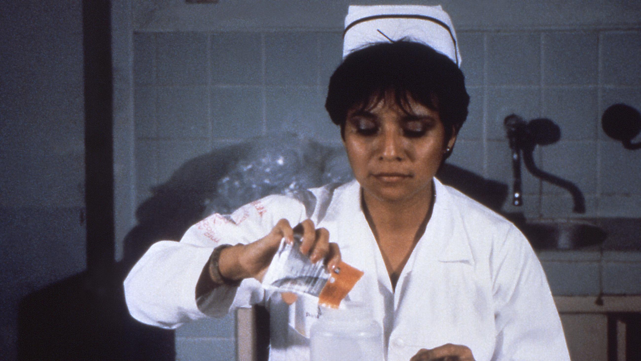 A nurse in 1992 mixing oral rehydration solution from a foil packet to address a case of severe dehydration from a Vibrio cholerae infection.