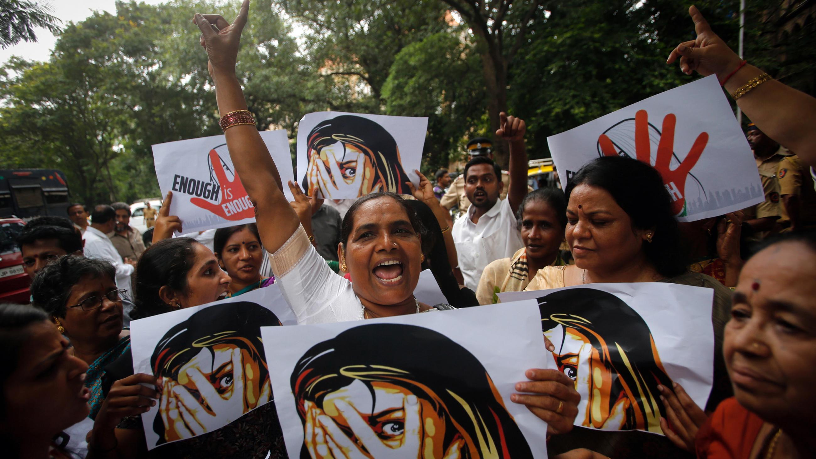 The photo shows a number of marchers with signs and fists raised in the air. 