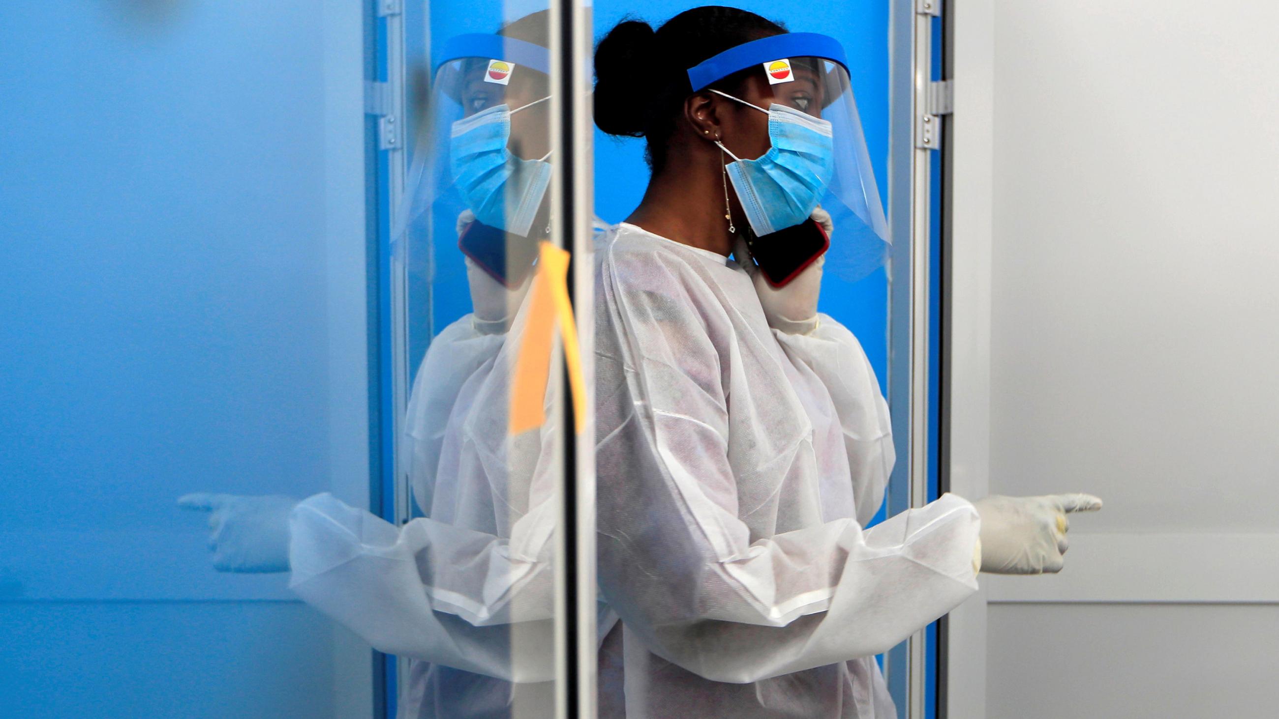 The photo shows the worker wearing protective gear and talking on the phone. 