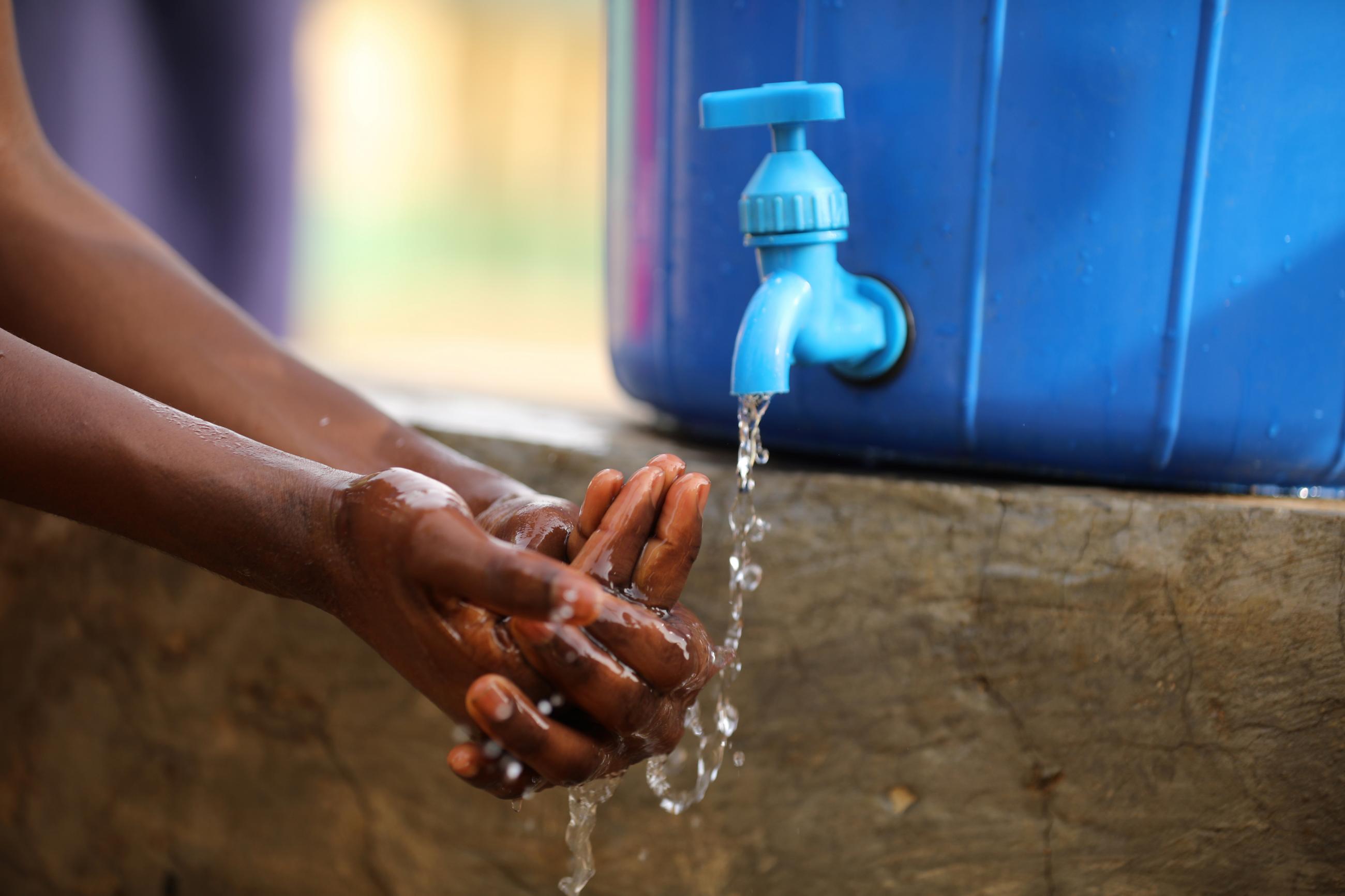 A student washes her hands at a school in Abuja, Nigeria, on March 20, 2020.