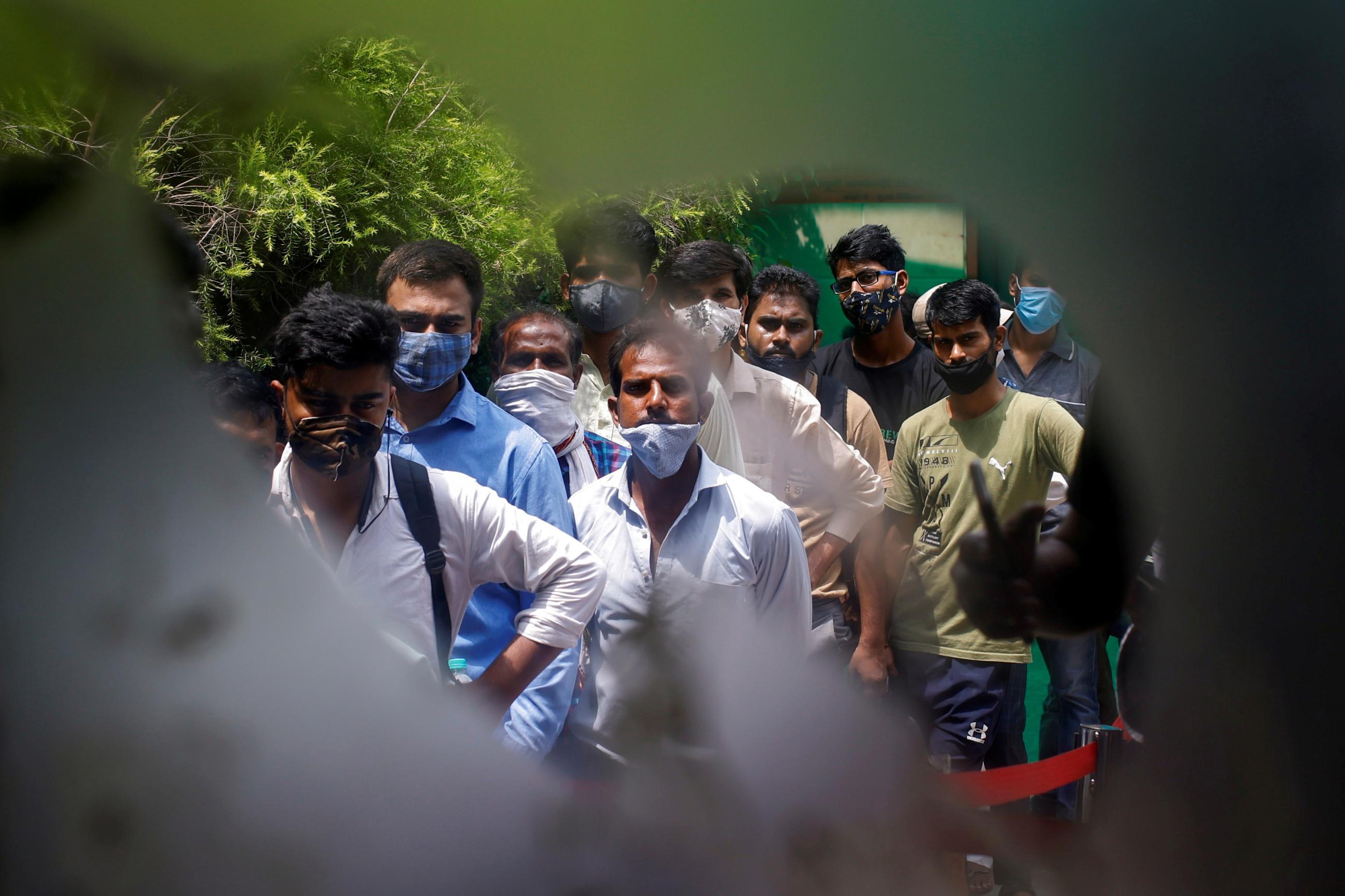 People wait to receive a dose of the COVISHIELD vaccine, made by the Serum Institute of India, at a hospital in Noida on the outskirts of New Delhi, India, August 30, 2021. 