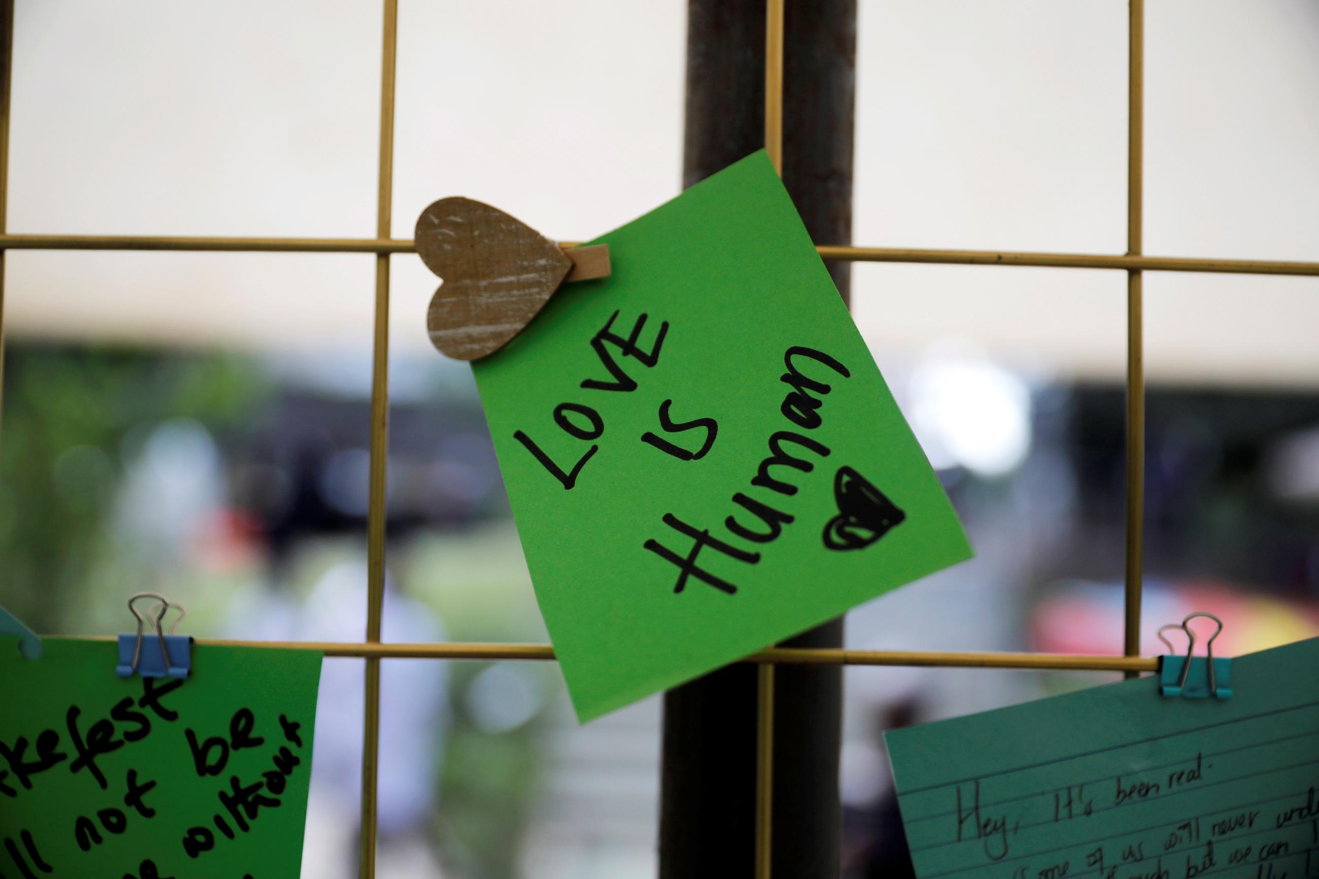 A tribute note on green paper to Kenyan author and LGBTQI+ activist Binyavanga Wainaina says says "Love is Human." Wainaina died in Nairobi in May 2019, at a memorial service at the Nairobi National Museum. 